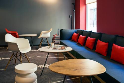 a living room with a blue couch with red pillows at ibis Jerusalem city Center - An AccorHotels Brand in Jerusalem