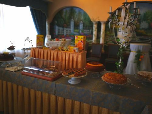 a buffet with pies and other food on a table at Hotel Lido - Beach and Palace in Bolsena