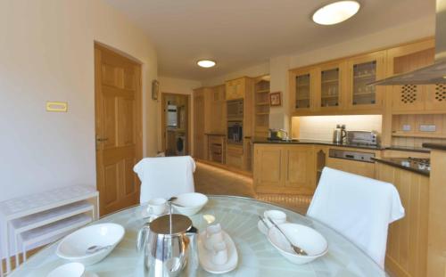 a kitchen with a table and two white chairs at Haddington Place in Dublin