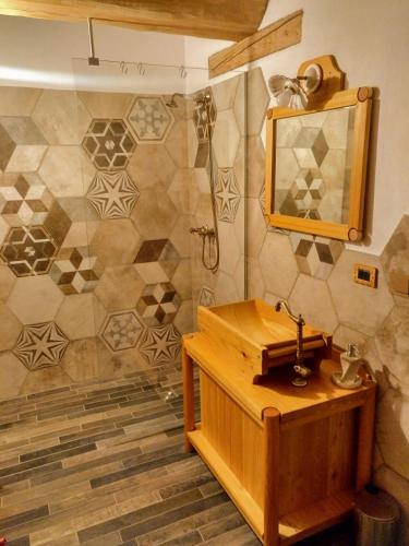 a bathroom with a wooden sink and a mirror at Delfin Dal Pianhol in Casteldelfino