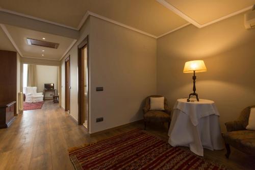 a living room with a table with a lamp on it at Hotel-Hostal Sport in Falset