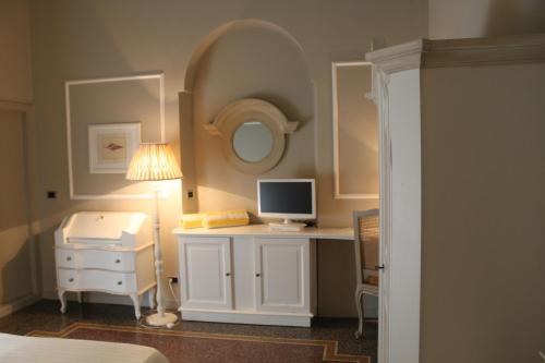 a bedroom with a desk with a computer and a lamp at Hotel Helvetia in Sestri Levante