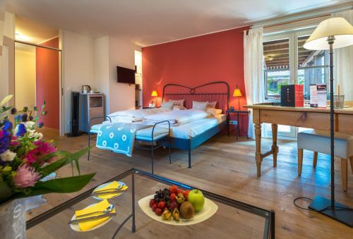 a bedroom with a bed and a table with a plate of fruit at Hotel Schindlerhof in Nürnberg