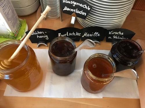 three mason jars of barbecue sauce on a table at Winzerhof - Gästehaus Stöger in Dürnstein