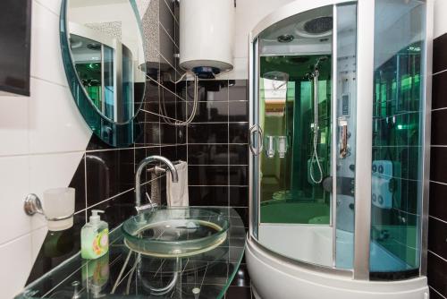 a bathroom with a glass sink and a mirror at Apartments G&M in Vodice