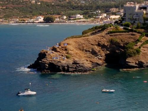 two boats in the water next to a rocky island at Bella Vista in Balíon