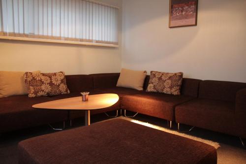 a living room with a couch and a table at Cafe Hotel Rudzons in Madona