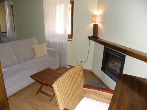 a living room with a couch and a fireplace at Casa Granero in Rascafría