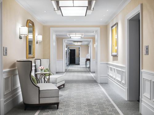 a corridor of a hotel room with a hallway at The Langham London in London