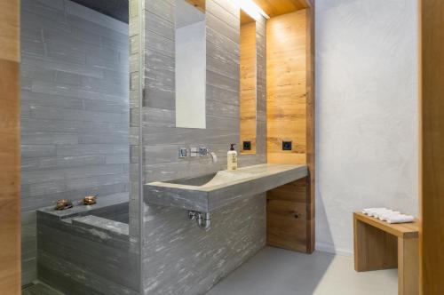 a bathroom with a sink and a mirror at rocksresort in Laax