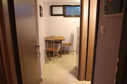 a hallway with a table and a dining room at Katina's House in Vourvourou