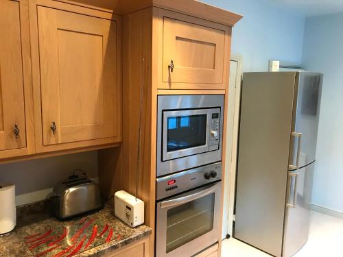 a kitchen with a microwave and a refrigerator at 7 Precentor's Court in York