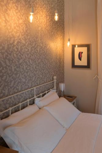 a bedroom with a bed and a wall at Assaporarte in Florence