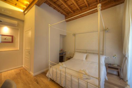 a bedroom with a white bed with a metal frame at Assaporarte in Florence