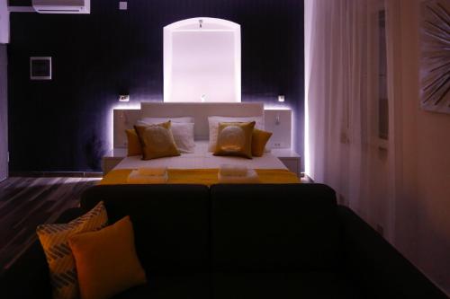 a bedroom with a bed and a couch in it at Studio Apartman Fictilis in Split