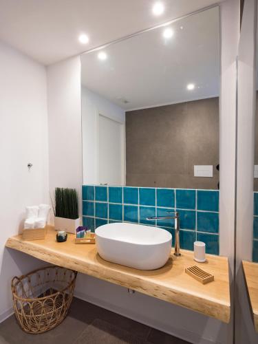 a bathroom with a large white sink and blue tile at B&b Don Giovanni in Maiori