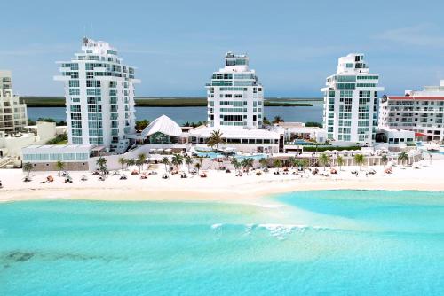 a view of a beach in front of buildings at Oleo Cancun Playa All Inclusive Resort in Cancún