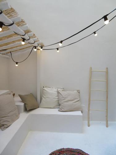 Habitación con cama con almohadas y escalera. en Mirmont Greek Style, en Burdeos