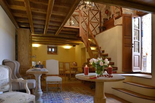 a living room with a table with flowers on it at Archontiko Chioti in Leonidion