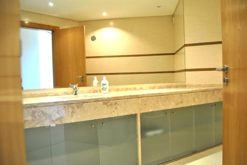 a bathroom with a sink and a mirror at Parque Nacoes Prime Apartments 16 - 3 quartos in Lisbon