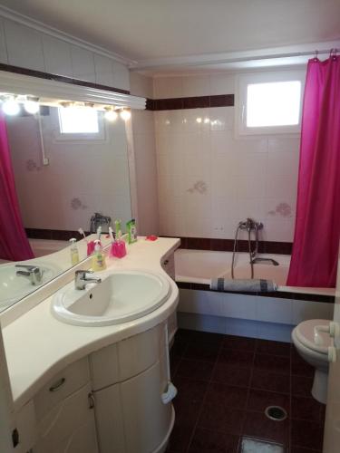 a bathroom with a sink and a tub at Assos Villa in Káto Ássos