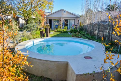 a swimming pool in the yard of a house at Mirabel Guesthouse in Parys
