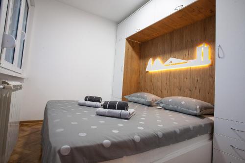 a bedroom with a bed with a wooden headboard at White Lux apartment in Belgrade