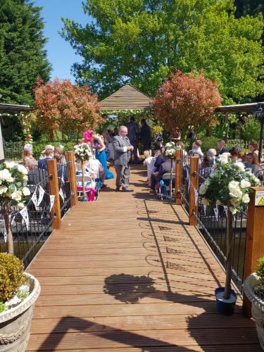 a man walking down a wooden walkway with a crowd of people at The Judds Folly Hotel, Sure Hotel Collection by Best Western in Faversham