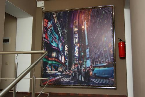 a large painting of a city on a wall at Helen Hotel in Mykolaiv
