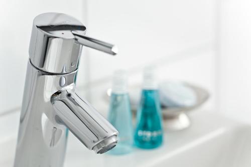 a bathroom sink with a silver faucet and toothpaste at Schnellenburg in Düsseldorf