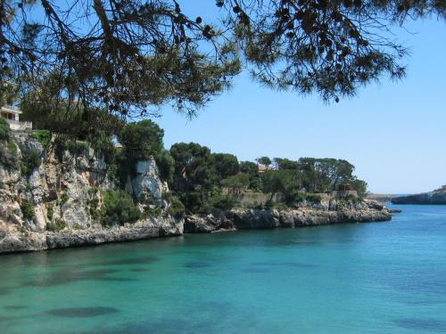 a view of a river with a rocky shore at Finca Son Blat in Porto Cristo