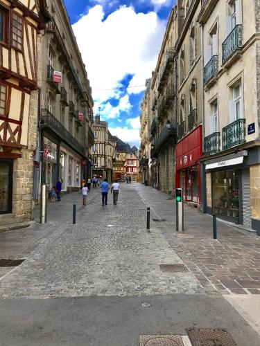 a city street with people walking down the street at Appartements de caractère centre in Vannes