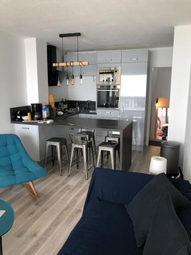 a kitchen and living room with a blue couch at Sunset lovers in Lacanau-Océan