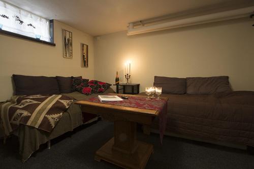 a living room with a couch and a table at Prinsgården B&B rum stugor in Mora