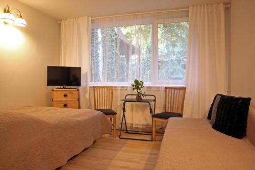 Ένα ή περισσότερα κρεβάτια σε δωμάτιο στο Hotel Zakątek Leśny