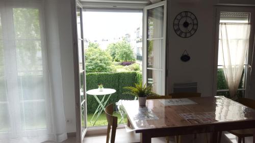 a dining room with a table and a large window at F&B's Home Disneyland Paris in Serris