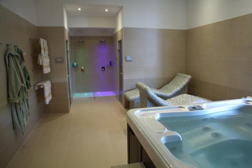 a bathroom with a tub and a sink and a shower at Zepter Hotel in Bosanska Dubica