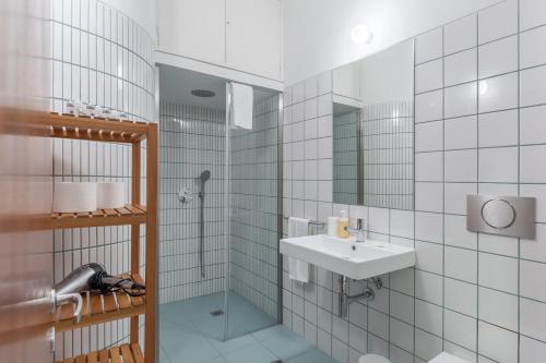 a bathroom with a sink and a shower at OPO Trindade Tower in Porto