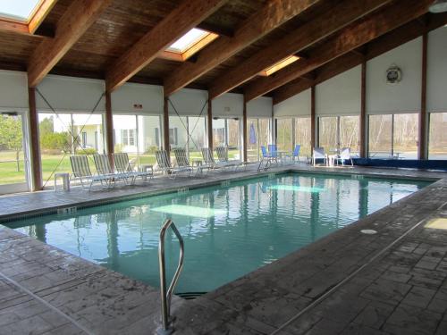 a large swimming pool with chairs in a building at Ocean Walk Hotel in Old Orchard Beach