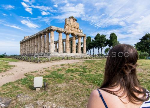 a woman standing in front of a temple at Casa Delle Rose in Capaccio-Paestum