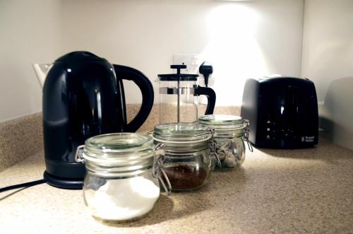 a kitchen counter with jars of food and a blender at Home Crowd Luxury Apartments in Doncaster