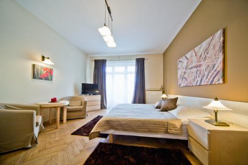 a bedroom with a bed and a living room at 4Seasons﻿ Apartments Cracow in Kraków