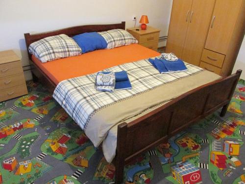 a bedroom with a bed with two blue towels on it at Country House Roman in Doboj