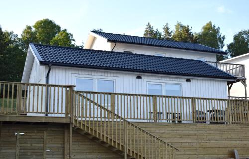 a house with a deck and a solar roof at Håveruds hotell och konferens in Håverud