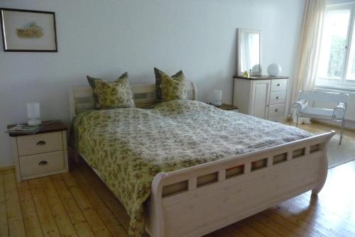 a bedroom with a large bed and two windows at Quartier an der Elbe in Dresden