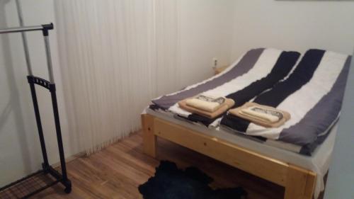 a bed with towels on top of it in a room at Santa Maria Apartment in Donji Kovilj