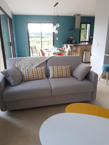 a living room with a couch with pillows on it at Gite Les Lavandes in Vaison-la-Romaine
