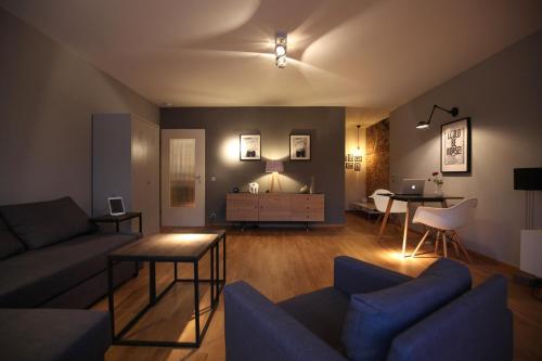 a living room with a couch and a table at 21st Appartement in Düsseldorf
