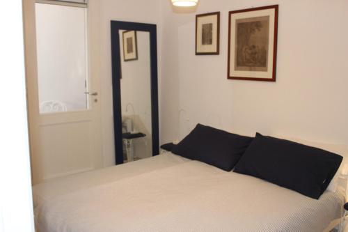 マッサ・ルブレンセにあるCasa Villaのベッドルーム(白いベッド、黒い枕付)