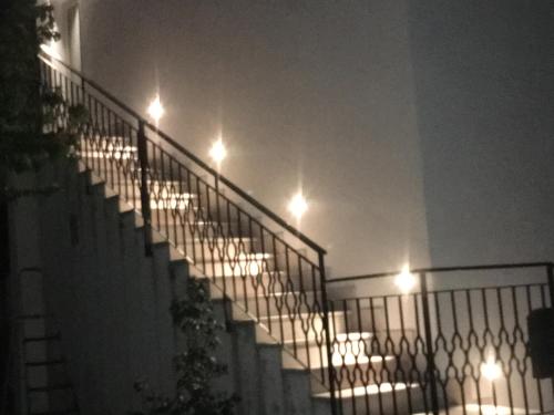 a group of stairs with lights on them at night at B&B Somiar in San Teodoro